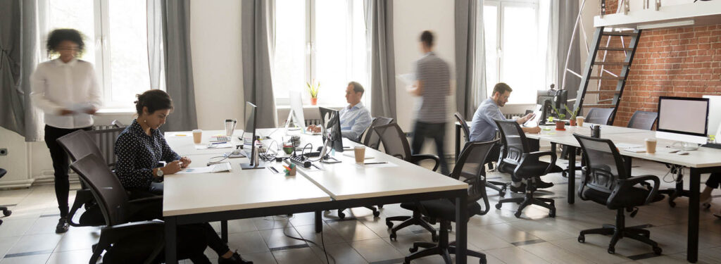 people hard at work in an open office